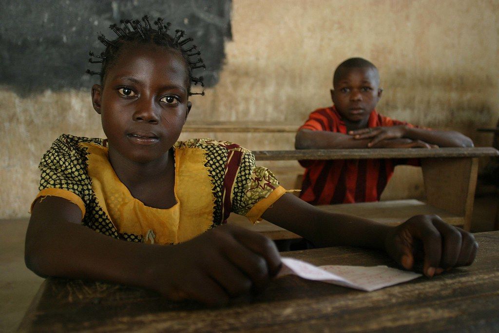 A girl and a boy at their desks in a primary school in Africa