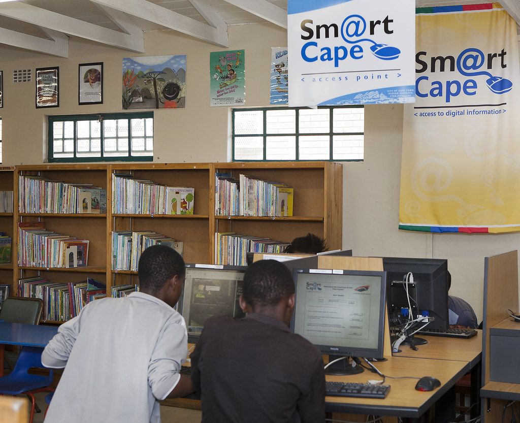 Young people using computers in a public library in Africa